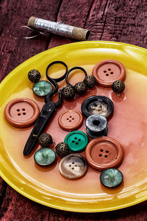 buttons and zipper on the background of sewing toolの写真素材