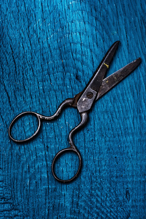 old scissors on a blue background from wood の写真素材