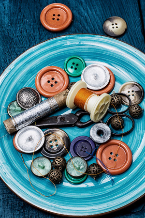buttons and zipper on the background of sewing toolの写真素材