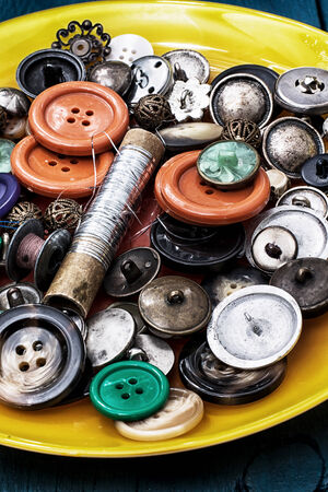 set of threads and buttons on the background of woodの写真素材