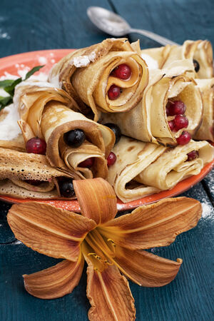 home-made pancakes with fruit and berry fillingsの写真素材