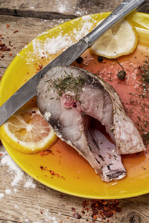 cut a slice of raw fish in lemon and spicesの写真素材