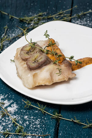 piece of fragrant roasted fish in sauce and spicesの写真素材