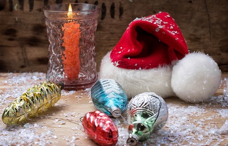 festive decoration with Christmas hat and a burning candleの写真素材