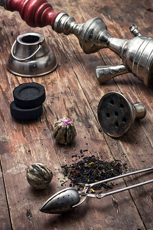 accessories to Smoking hookah and dry tea leaves.image is tinted in vintage styleの写真素材