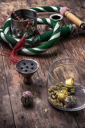 accessories to Smoking hookah and dry tea leaves.image is tinted in vintage styleの写真素材