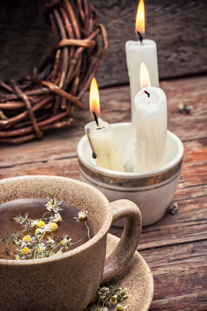 fragrant chamomile tea and burning candles in rustic style.Selective focusの写真素材