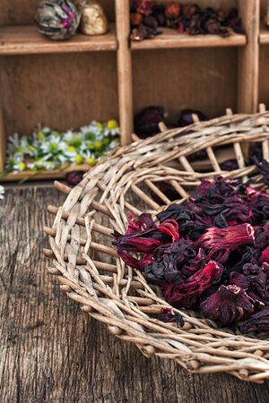 Hibiscus tea rose and welding on the background of the tea shelves in vintage style.Photo tintedの写真素材