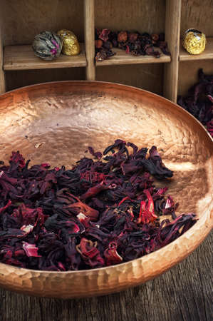 Hibiscus tea rose and welding on the background of the tea shelves in vintage style.の写真素材