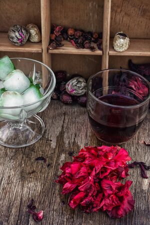 Hibiscus tea rose and welding on the background of the tea shelves in vintage style.の写真素材