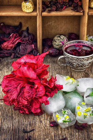 Hibiscus tea rose and welding on the background of the tea shelves in vintage style.Photo tinted.Selective focusの写真素材