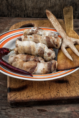 pork sausages on a plate on a wooden board rusticの写真素材
