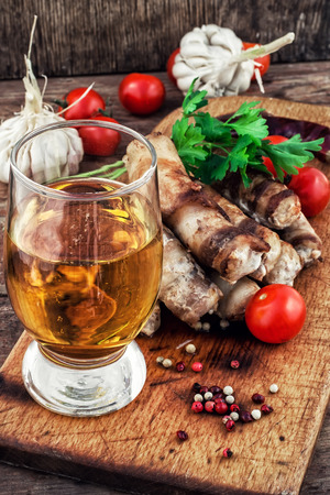 fragrant grilled meat sausages in tomato with a glass of light beer.Selective focus.Photo tintedの写真素材