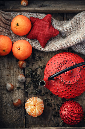 Red tea,tangerines,hazelnuts and scattered tea leaves.Top viewの写真素材