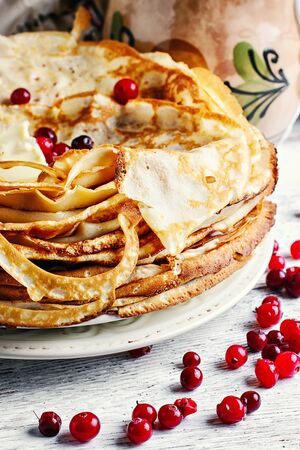 Freshly baked pancakes on a light background for the holiday carnivalの写真素材