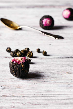 Several types of leaf tea light on bright wooden background.Photo in high keyの写真素材