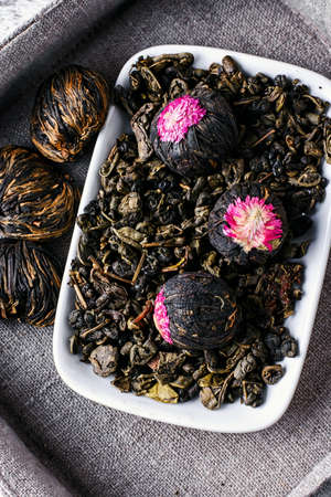 Several types of leaf tea light on a bright wooden background.Top viewの写真素材