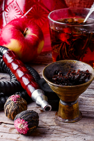 Cup of brewed herbal tea from rose and Turkish hookahの写真素材