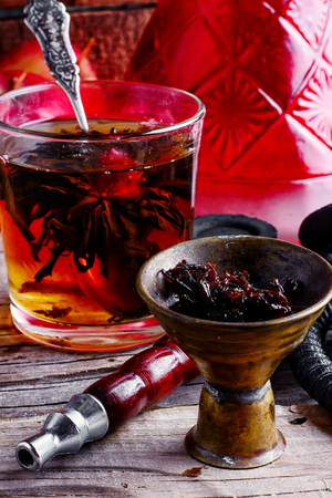 Cup of brewed herbal tea from rose and Turkish hookahの写真素材