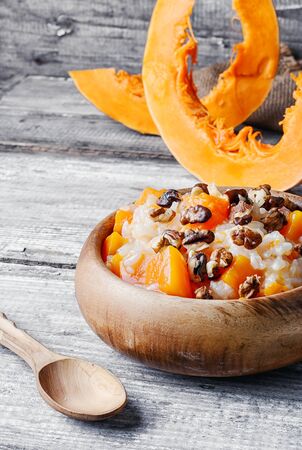 Porridge with pumpkin in a stylish wooden bowl, rusticの写真素材