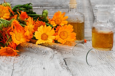 bottle of medicinal tincture of calendula flowers in folk recipeの写真素材
