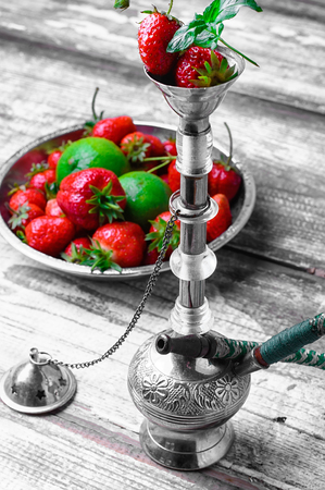 Small smoking hookah with strawberry,mint and limeの写真素材