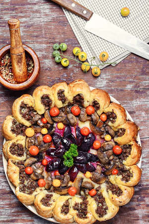 Delicious homemade steak pie with vegetables and plum jam in rustic styleの写真素材