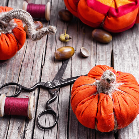 Sewing decorative pumpkins from fabric for autumn decorationsの写真素材