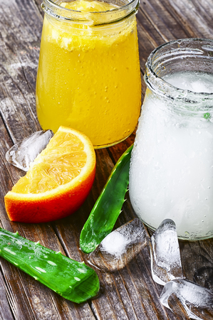 glass of medicinal drink sap from aloe leaf and orangeの写真素材