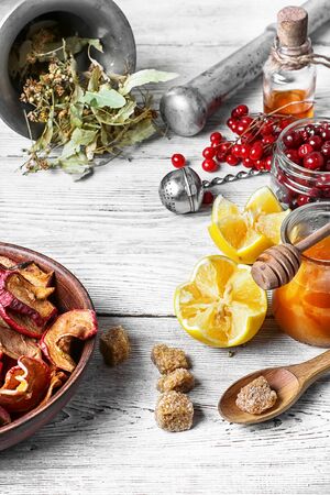 Mortar,linden,dried apples and lemon as medicinal ingredientsの写真素材