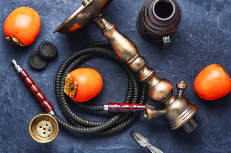 Smoking hookah with the tobacco flavor with the taste of ripe persimmonsの写真素材