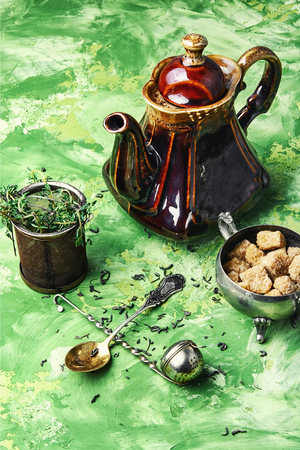 Porcelain teapot with herbal infusion of healing herbs.の写真素材