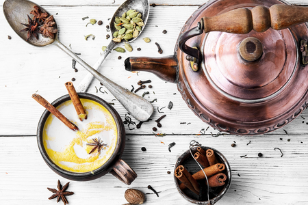 Masala tea in clay mug with spices on light background.の写真素材