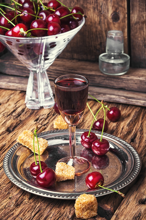 Homemade alcohol tincture from summer cherry berriesの写真素材