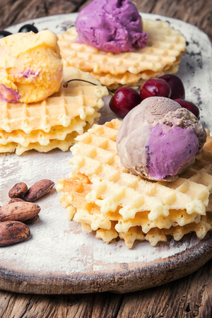 Ice cream on baked wafers with cherriesの写真素材