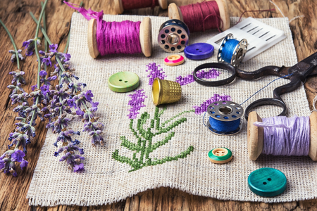 Embroidery bouquet of lavender and tools of needleworkの写真素材