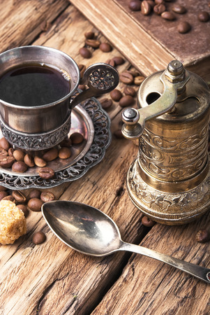 Vintage set with a cup of coffee on saucer in oriental styleの写真素材