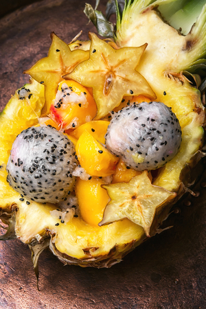 Vegetarian food.Exotic fruit salad of tropical fruit in pineappleの写真素材