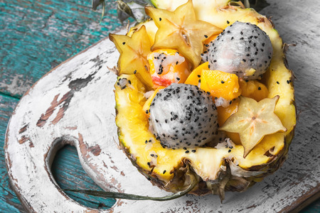 Exotic fruit salad of tropical fruit in pineappleの写真素材