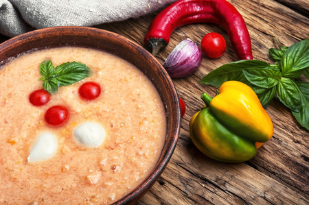 Gazpacho soup with basil on the old wooden backgroundの写真素材