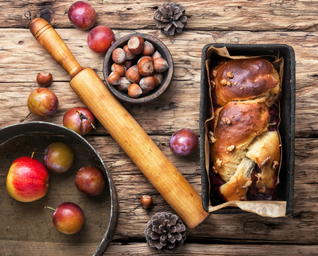 Homemade cupcake with apples and plum in baking dishの写真素材