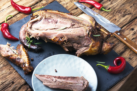 roasted duck with apples on the kitchen cutting boardの写真素材