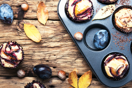 Plum cupcake on background with autumn leavesの写真素材