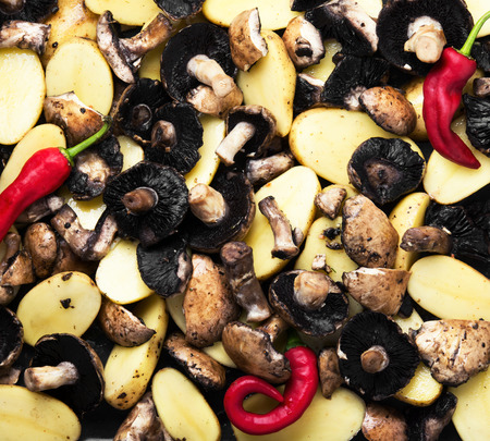 background of raw meat and potatoes on a baking trayの写真素材