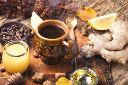 cup with therapeutic tea from the root of ginger, honey and lemonの写真素材