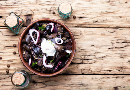 glass of cognac and a snack from forest salted mushroomsの写真素材