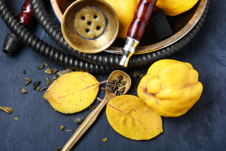 Smoking smoking hookah in Arabic style with the tobacco aroma of ripe quinceの写真素材