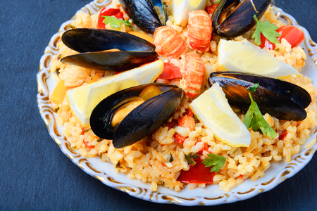 vegetable paella with seafood from rice, mussels and lemonの写真素材
