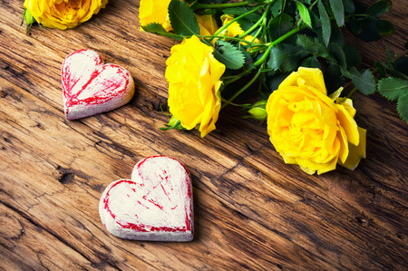 Bouquet of yellow roses and symbolic red hearts.Postcard for Valentine Dayの写真素材