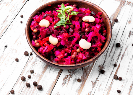 Traditional vegetarian russian beetroot salad vinaigrette in rustic recipeの写真素材